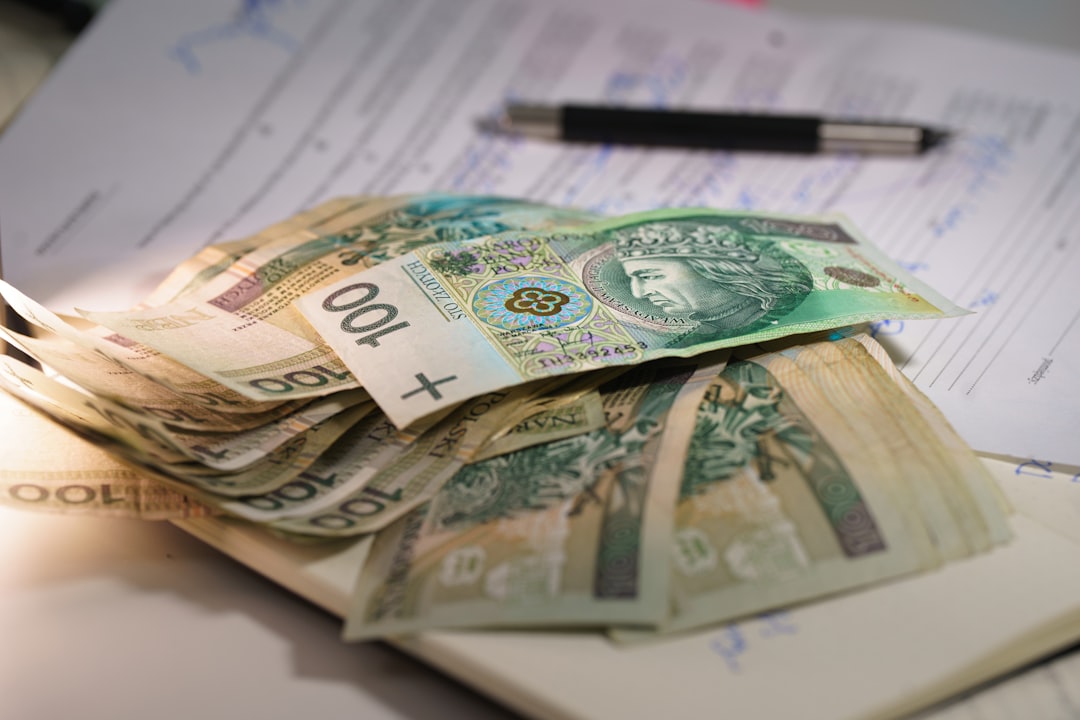 Stack of polish currency banknotes on papers.