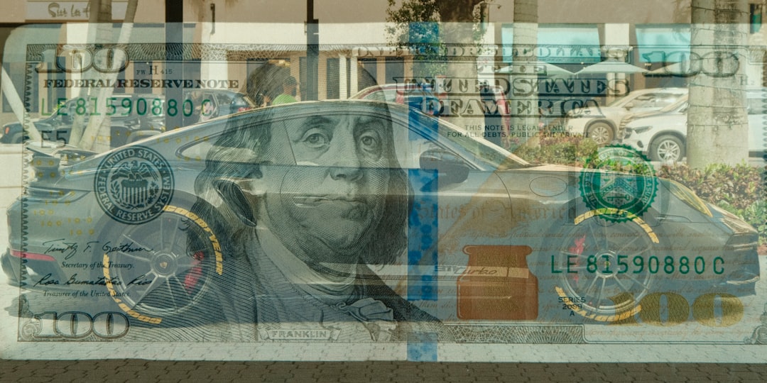 Luxury car superimposed over a hundred dollar bill.
