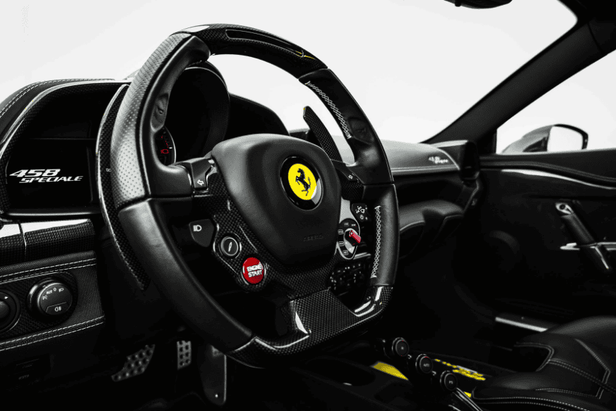 Volante esportivo com base achatada e múltiplos controles em uma Ferrari 458 Speciale.